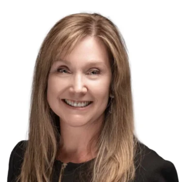 Woman with straight, light brown hair wearing a black zippered top, smiling, and facing slightly to the side against a white background.