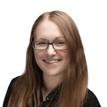A person with long light brown hair and glasses is smiling, wearing a black blazer over a dark shirt, against a white background.