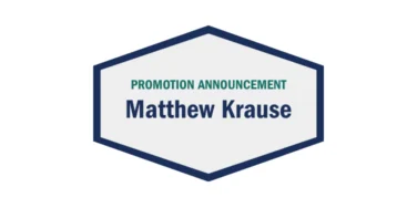 Hexagonal graphic with a navy border reads “Promotion Announcement Matthew Krause” in bold letters on a white background.